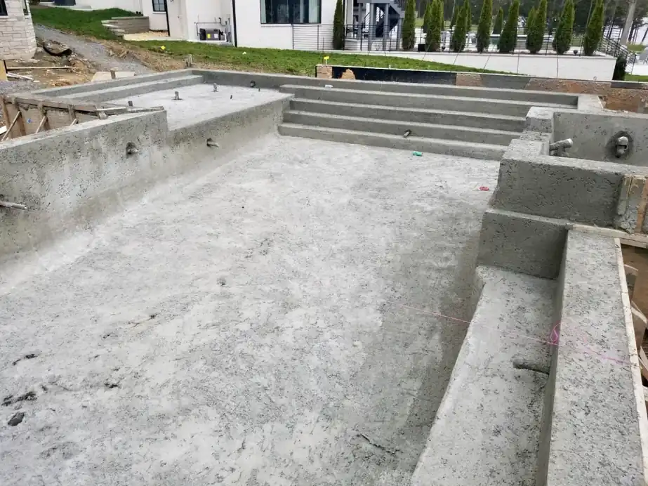 Finished gunite pool shell with built-in steps, before plaster