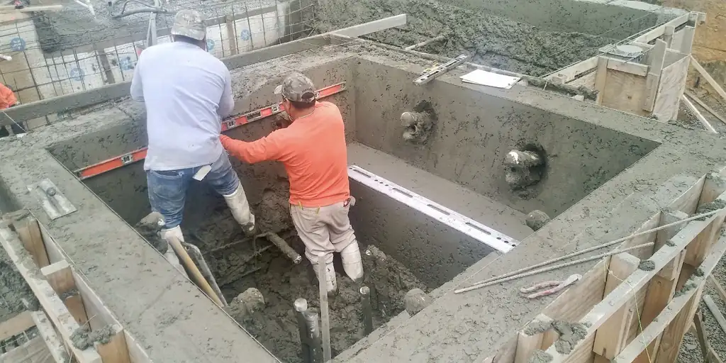 Two crew members levelling a spa shell